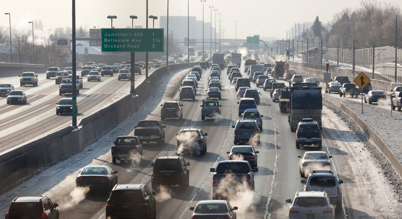 Cars on I-25 with exhaust fumes