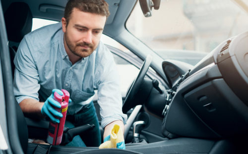 Man cleaning car's interior