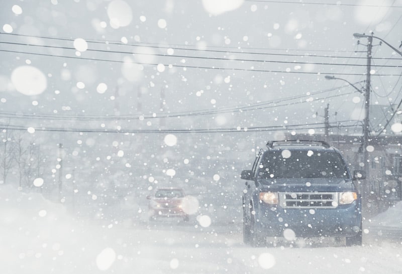 SUV driving in a snowstorm