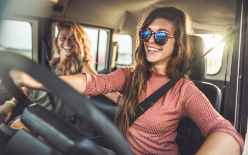two friends singing in the car