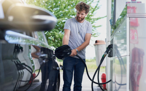 Man fueling up his vehicle at the pump