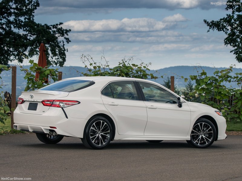 white Toyota Camry parked on mountain