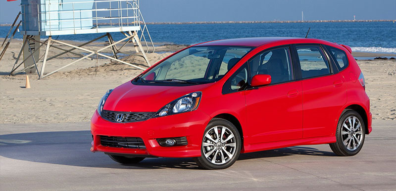 Red 2011 Honda Fit Parked by Beach