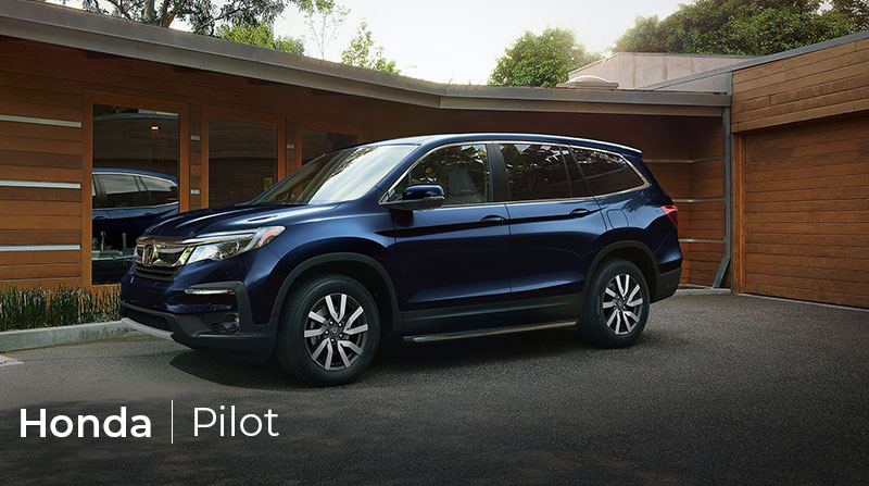Blue 2020 Honda Pilot parked in front of house
