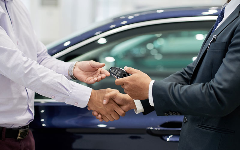 Person receiving new car keys