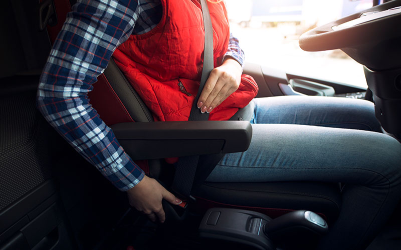 Driver putting on seatbelt