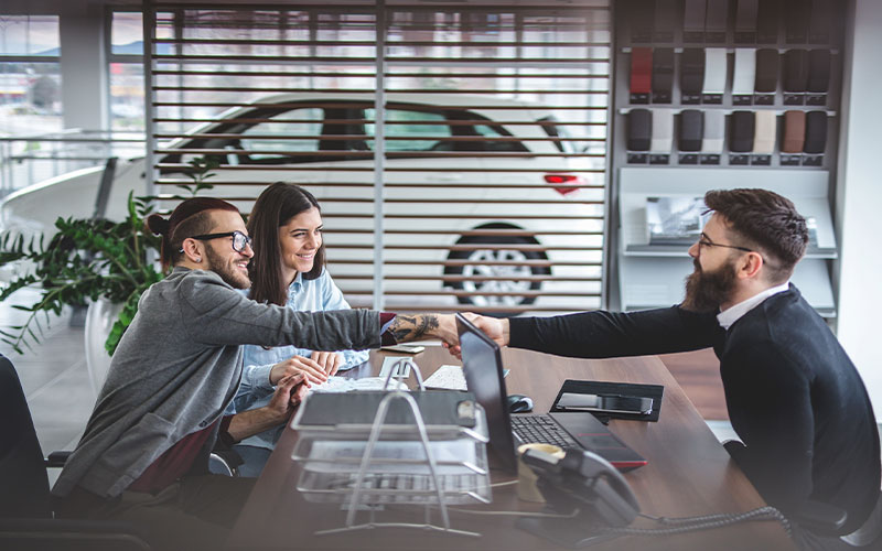 Customer and salesman shaking hands Customer and salesman shaking hands