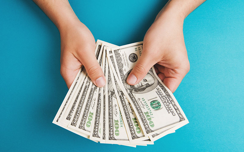 Person paying with cash Person paying with cash