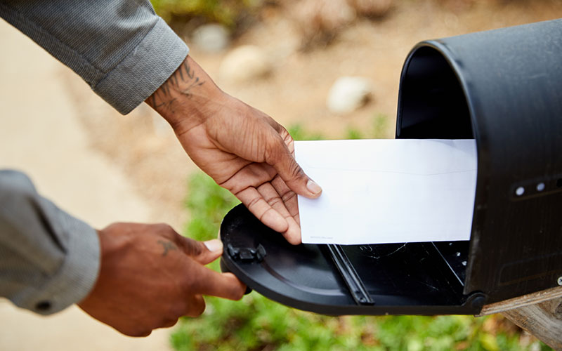 Person checking mailbox Person checking mailbox