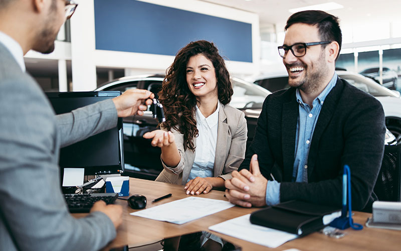 Customer receiving keys to her new vehicle Customer receiving keys to her new vehicle