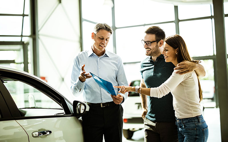 Couple looking at a new vehicle