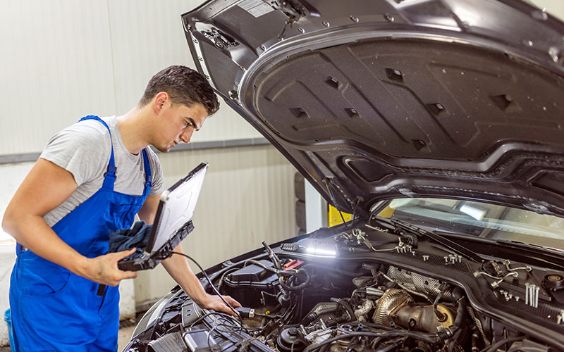 Mechanic checking diagnostic codes