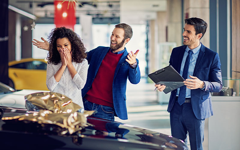 Husband gifting his wife with a car