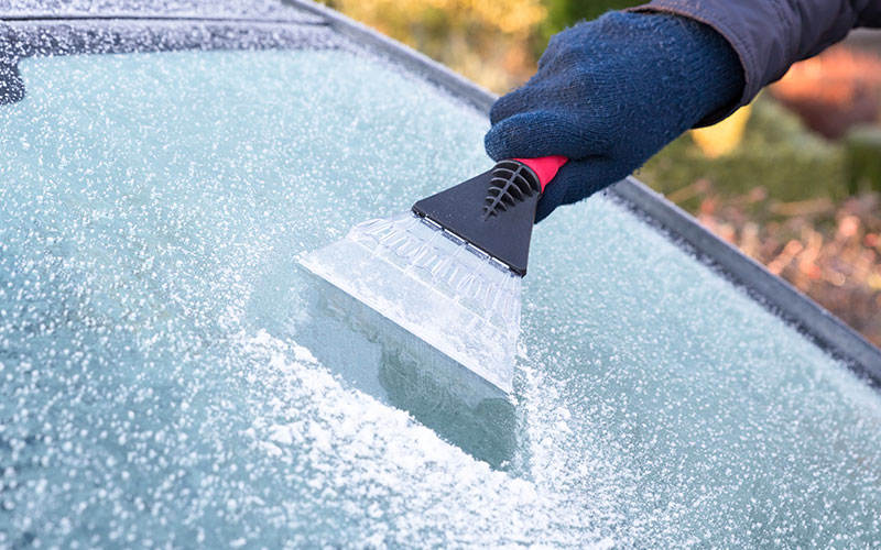 Scraping ice off of a windshield