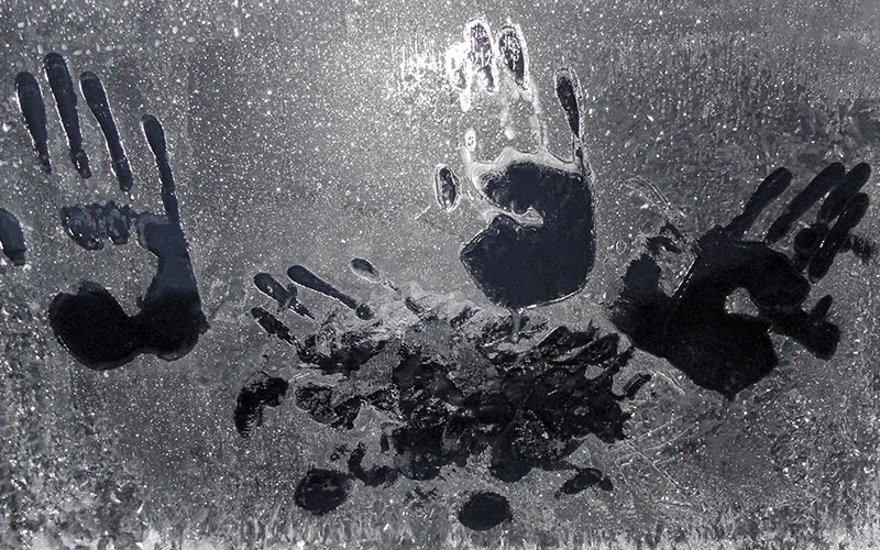 Handprints on frozen glass