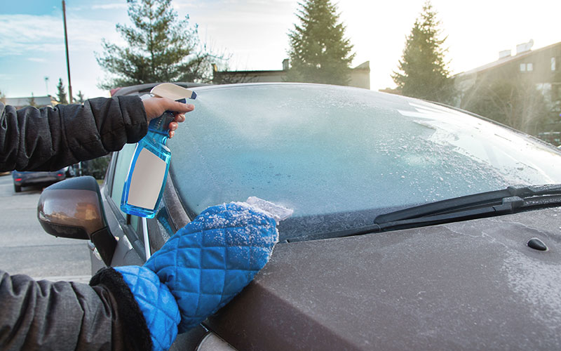 Using a de-icing spray before scraping