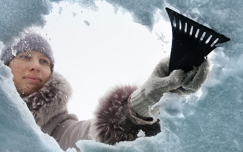 Scraping ice off of a windshield