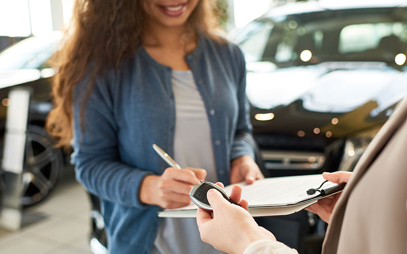 Woman signing paperwork