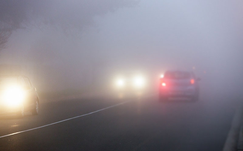 Cars driving through fog