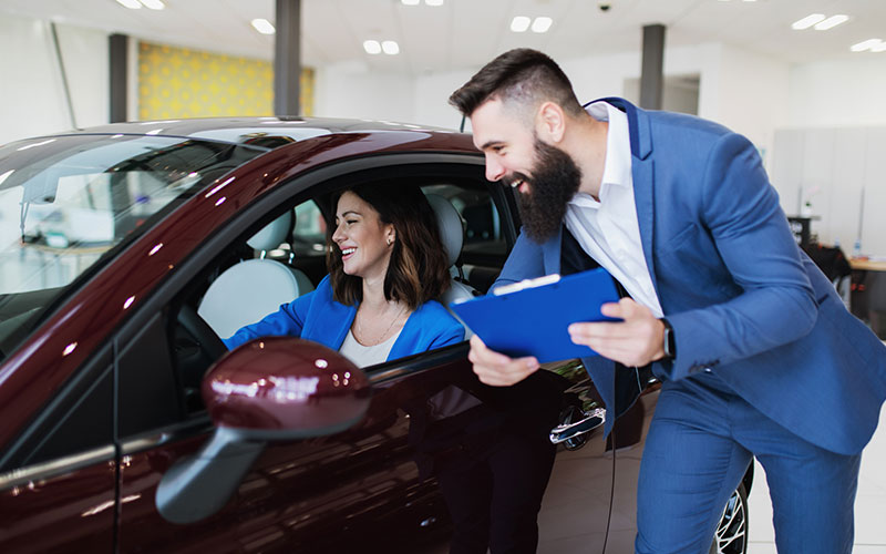 Woman looking at a new car Woman looking at a new car