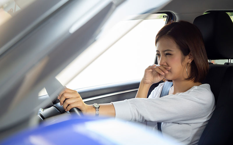 Driver noticing bad smell in car Driver noticing bad smell in car