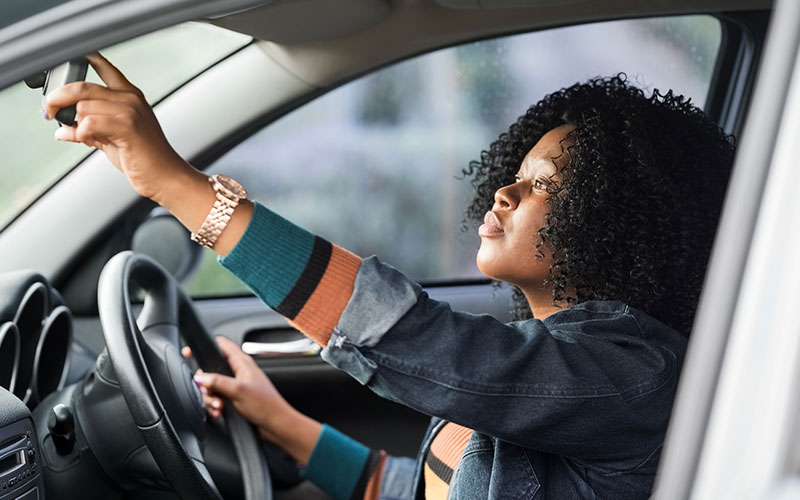 Driver checking her rearview mirror