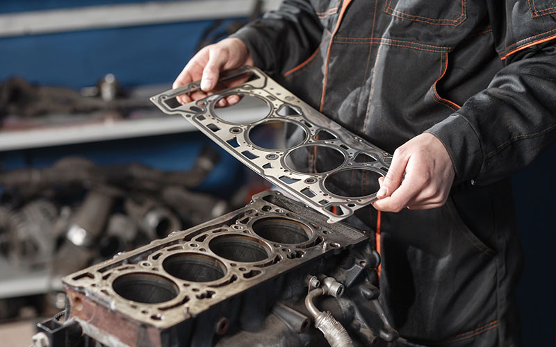 Mechanic holding a head gasket