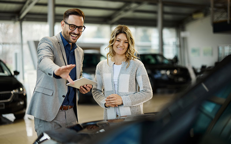 Salesman and buyer discussing a vehicle