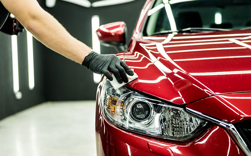 Person waxing their car Person waxing their car
