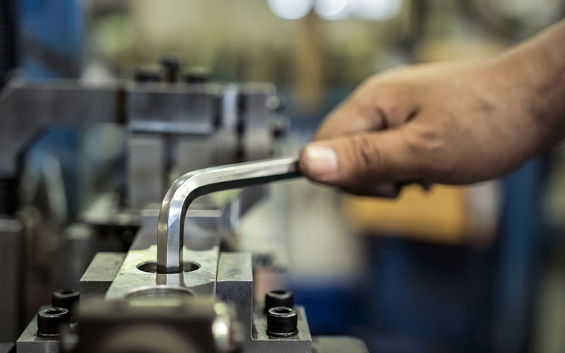Worker using a hex key