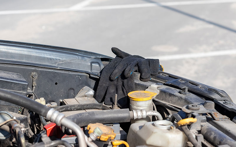 Work gloves draped over engine bay