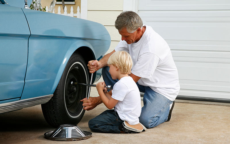 Man using a lug wrench on a tire