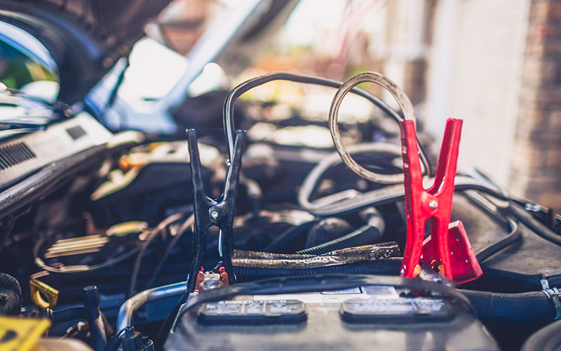 Jumper cables connected to a battery