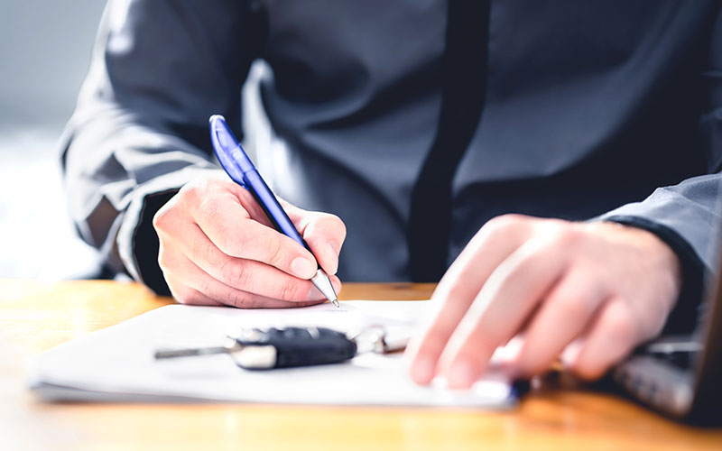 Signing paperwork for a new car