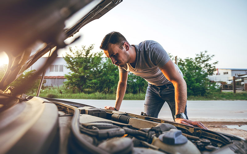 Man checking under the hood