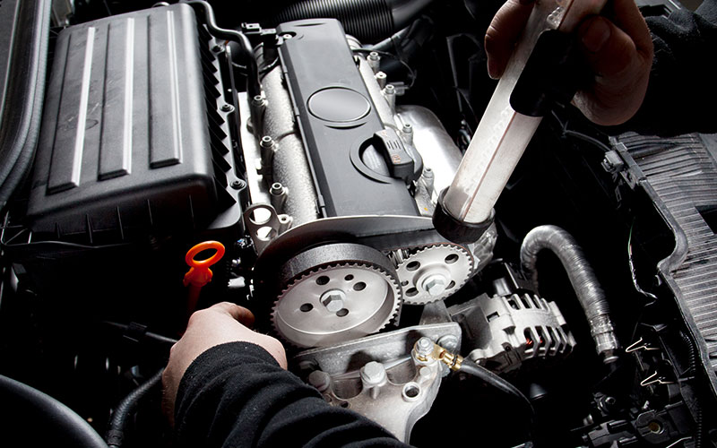 Mechanic checking out a timing belt