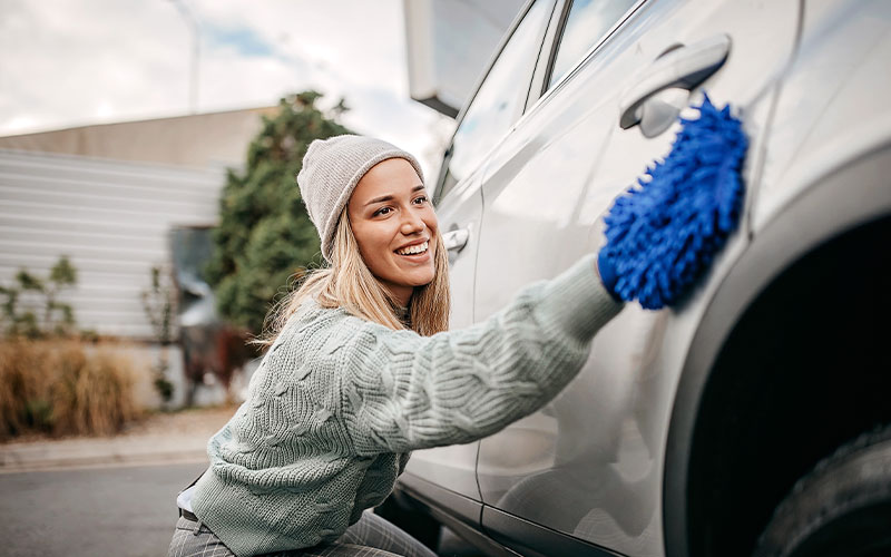 Woman cleaning car Woman cleaning car