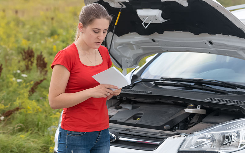 Woman reading owner's manual Woman reading owner's manual