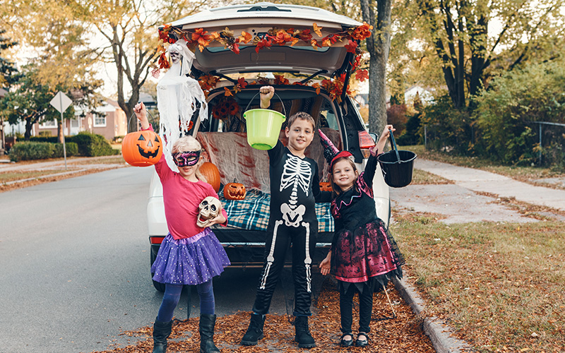 Trick or Treaters in front of decorated SUV