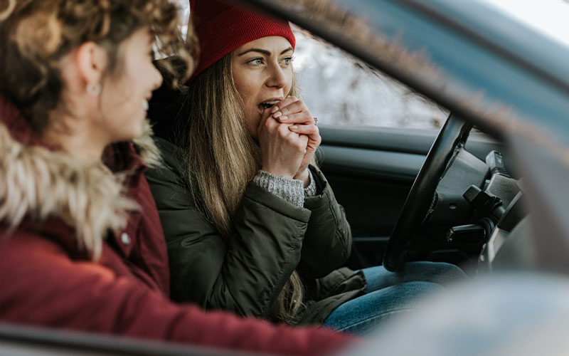 Driver heating her hands in her car Driver heating her hands in her car