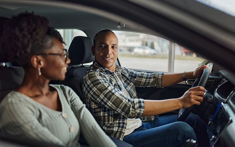 Couple test driving car