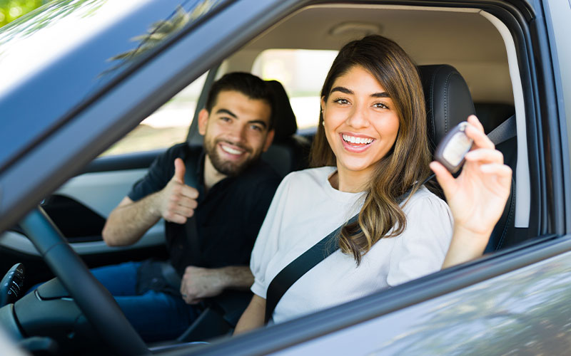 Happy couple with new car