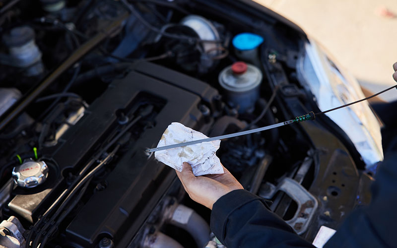 Mechanic checking car's oil