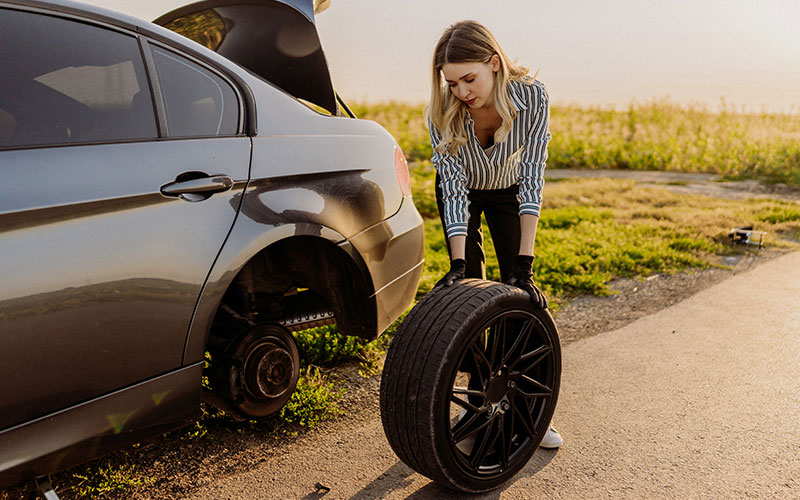 Woman changing tire