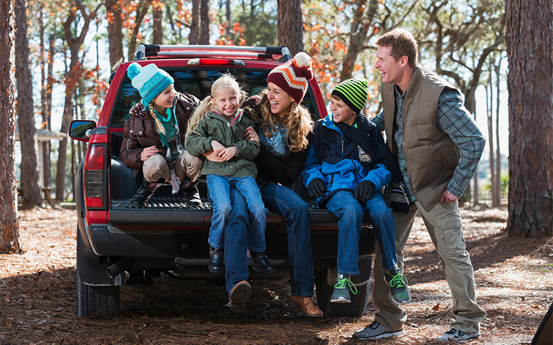 Family sitting on their truck bed