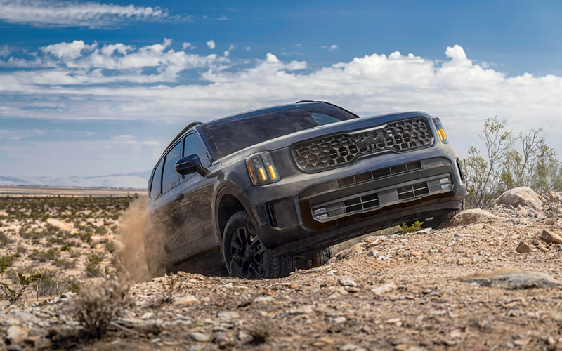 a gray kia telluride off roading