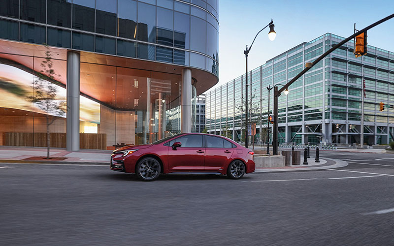 Red 2026 Corolla driving in a city