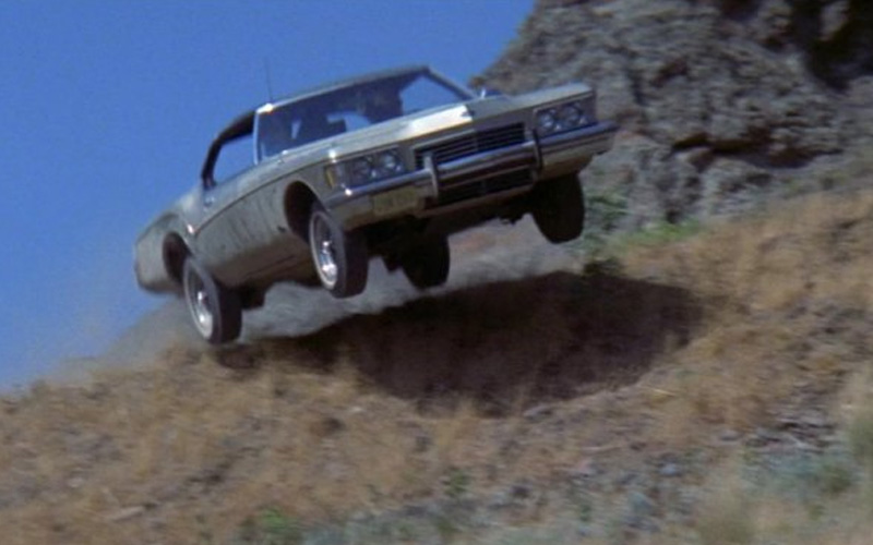 An Autumn gold 1973 Buick Riviera during a car chase in the movie "Thunderbolt and Lightfoot"