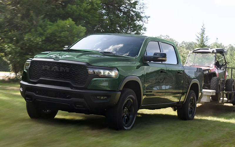 2026 Ram 1500 Hero Img Green 2026 Ram 1500 towing a 4-wheeler