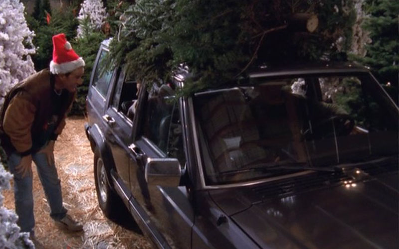 1990 Jeep Cherokee with Christmas tree on top